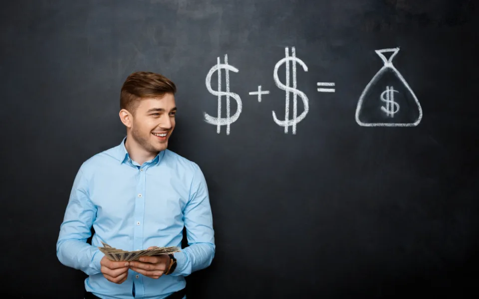 handsome-man-standing-blackboard-with-drawn-dollar-concept